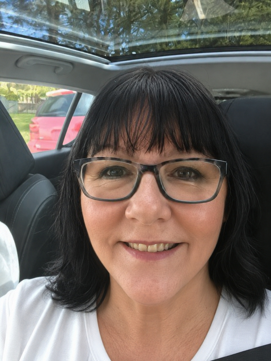 Smiling woman sitting in car